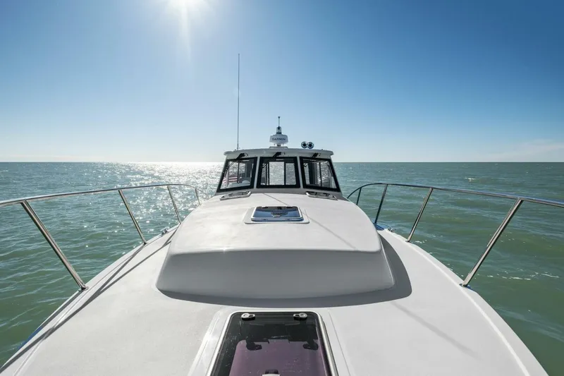 Slide: The Image of 2026 MJM 47R yacht cruising on open sea under clear blue sky. - 34