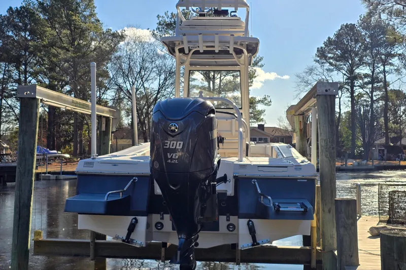 Slide: The Image of 2022 Robalo 246 Cayman SD boat with Yamaha 300 V6 engine at dock. - 2