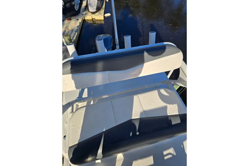 Slide: The Image of 2022 Robalo 246 Cayman SD boat seat with dock view. - 22