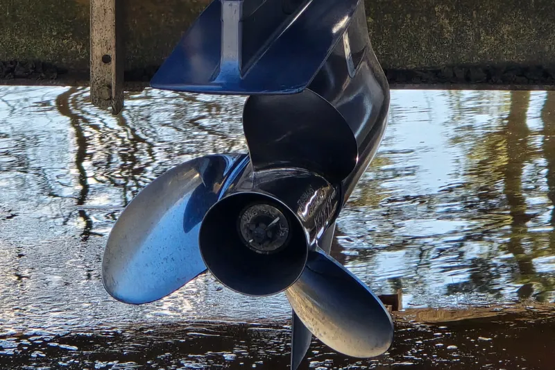 Slide: The Image of Close-up of a 2022 Robalo 246 Cayman SD boat propeller in water. - 23