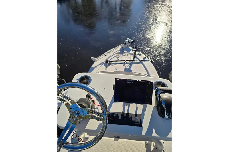 Slide: The Image of 2022 Robalo 246 Cayman SD boat dashboard with steering wheel and navigation system. - 24