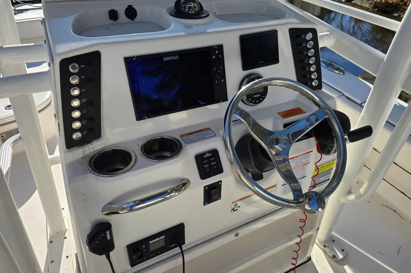 Slide: The Image of Control panel of 2022 Robalo 246 Cayman SD boat with steering wheel and navigation system. - 5