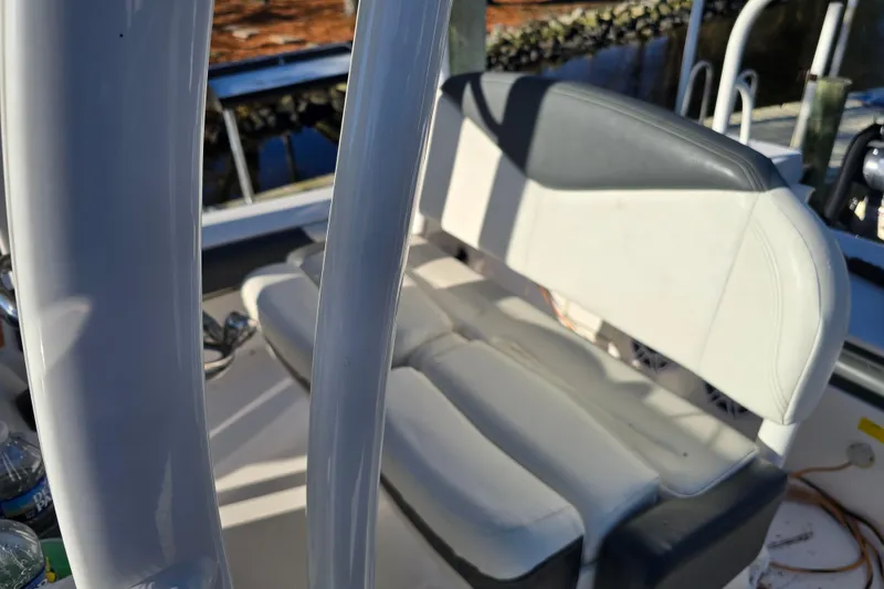 Slide: The Image of 2022 Robalo 246 Cayman SD boat interior with white and gray seating. - 9