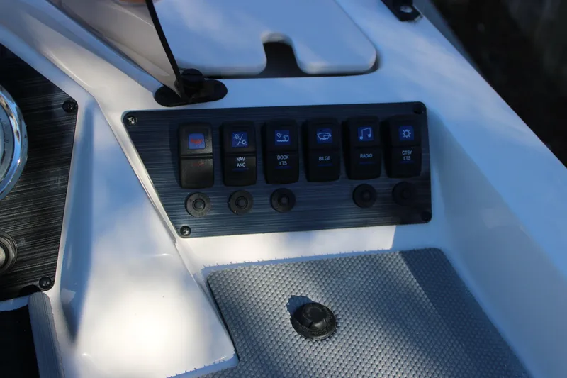 Slide: The Image of Control panel of 2026 Starcraft SV 18 OB boat with various switches. - 15