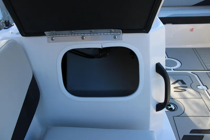 Slide: The Image of 2026 Starcraft SV 18 OB boat storage compartment with open hatch and handle. - 23