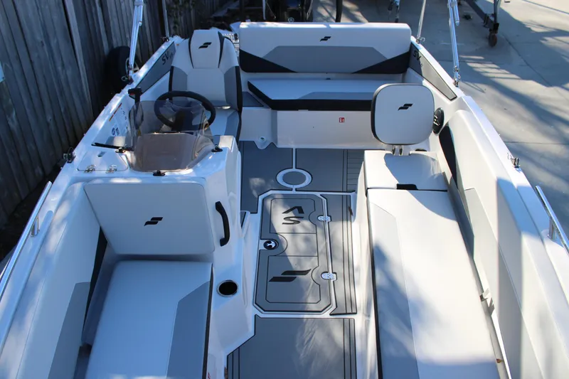 Slide: The Image of Interior view of 2026 Starcraft SV 18 OB boat, featuring sleek seating and modern design. - 26