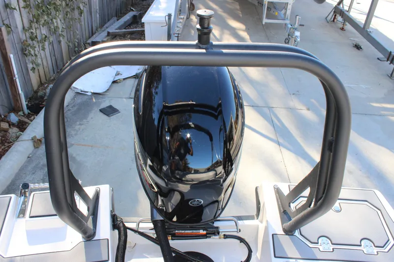 Slide: The Image of 2026 Starcraft SV 18 OB boat engine with protective railing in a driveway. - 7