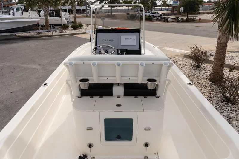 Slide: The Image of 2021 ShearWater 25LTD boat with Garmin navigation, docked in a marina setting. - 10