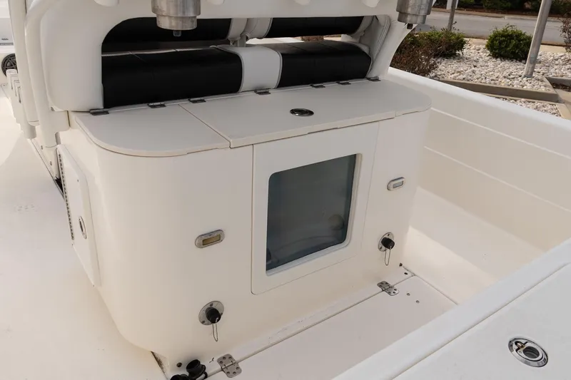 Slide: The Image of 2021 ShearWater 25LTD boat interior with seating and storage compartment. - 11