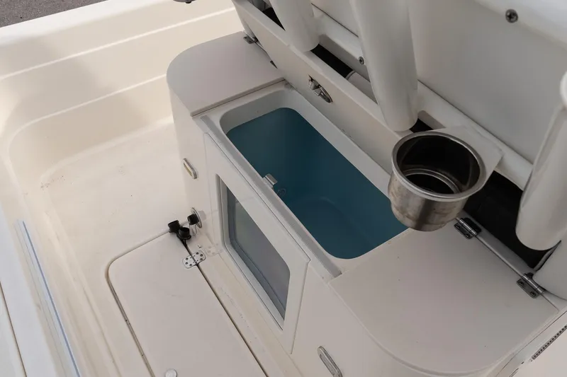 Slide: The Image of 2021 ShearWater 25LTD boat interior with storage compartment and cup holder. - 12