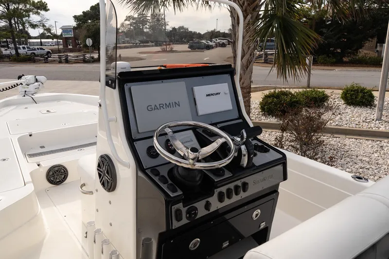 Slide: The Image of 2021 ShearWater 25LTD boat dashboard with Garmin and Mercury displays. - 14