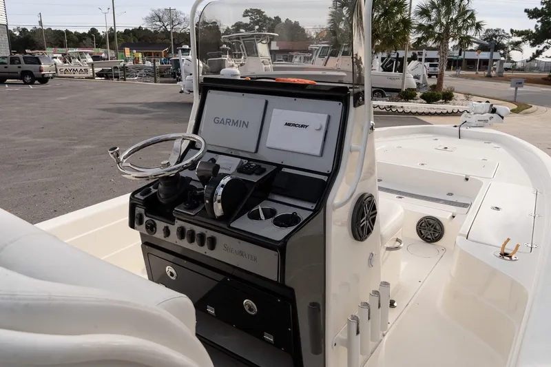 Slide: The Image of 2021 ShearWater 25LTD boat interior with Garmin and Mercury controls. - 15
