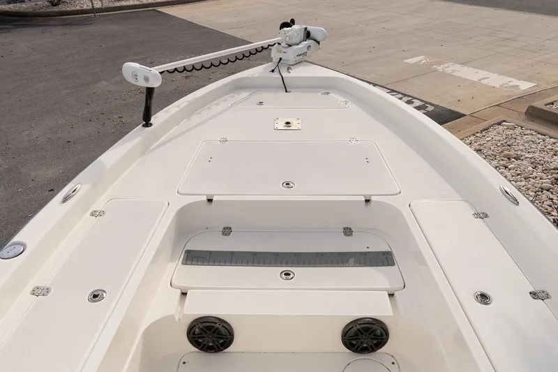 Slide: The Image of 2021 ShearWater 25LTD boat deck with trolling motor and storage compartments. - 16