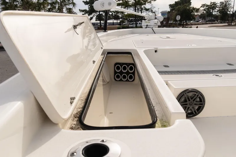 Slide: The Image of 2021 ShearWater 25LTD boat storage compartment with rod holders and speaker. - 17