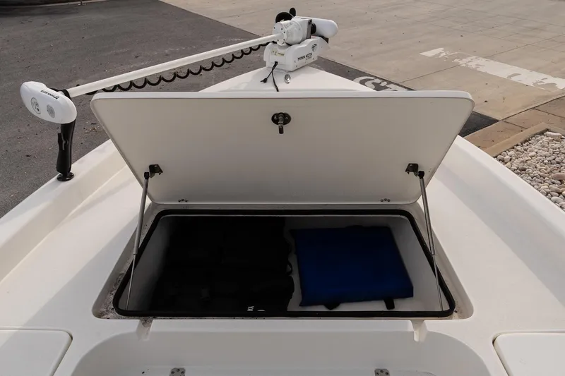 Slide: The Image of Open storage compartment on 2021 ShearWater 25LTD boat, showing interior contents. - 19