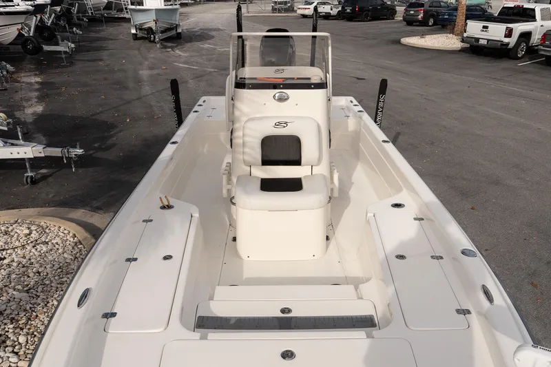 Slide: The Image of 2021 ShearWater 25LTD boat, white interior, parked in a dealership lot. - 20
