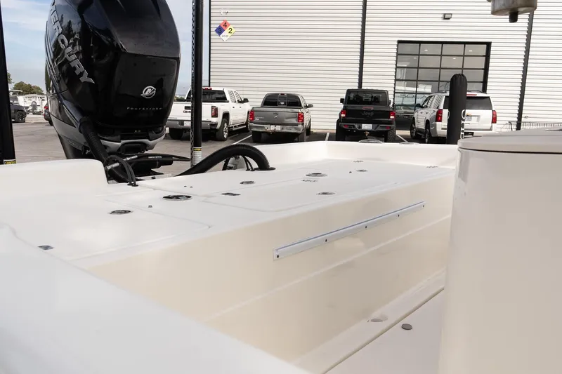 Slide: The Image of 2021 ShearWater 25LTD boat with Mercury engine, parked near trucks. - 7