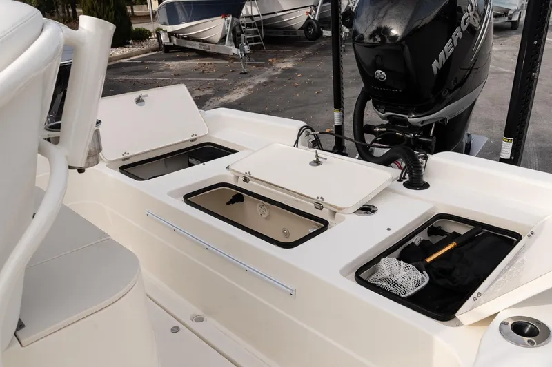 Slide: The Image of 2021 ShearWater 25LTD boat with open storage compartments and Mercury engine. - 8