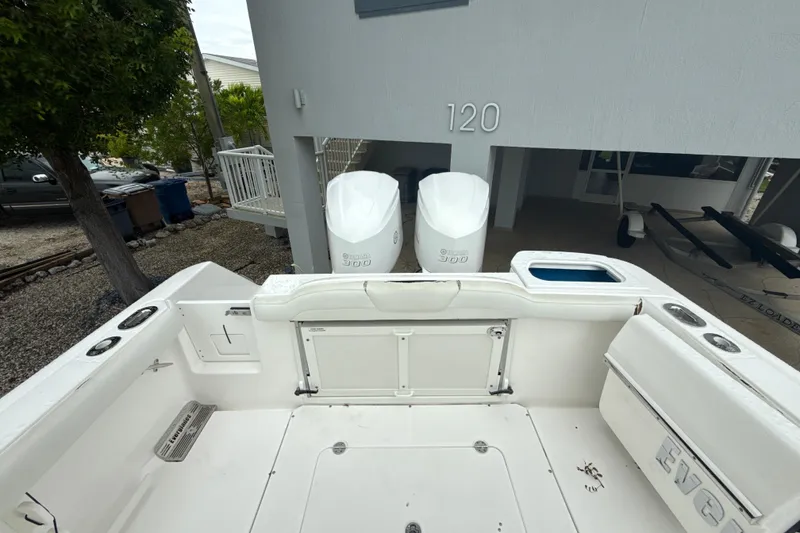 Slide: The Image of 2016 Everglades 295 Center Console boat with dual Yamaha 300 engines, parked near a house. - 10