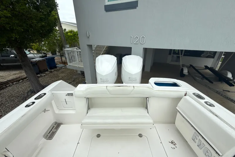 Slide: The Image of 2016 Everglades 295 Center Console boat with twin Yamaha 300 engines, docked near a house. - 11