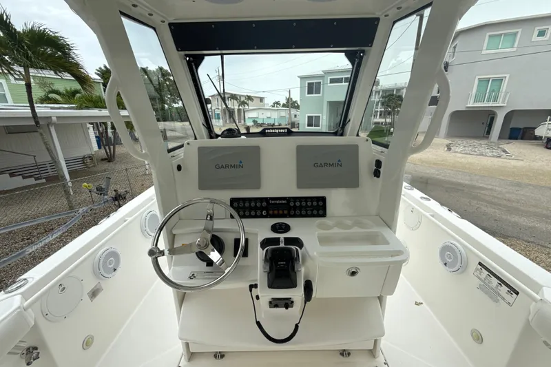Slide: The Image of 2016 Everglades 295 Center Console boat helm with Garmin navigation system and steering wheel. - 12