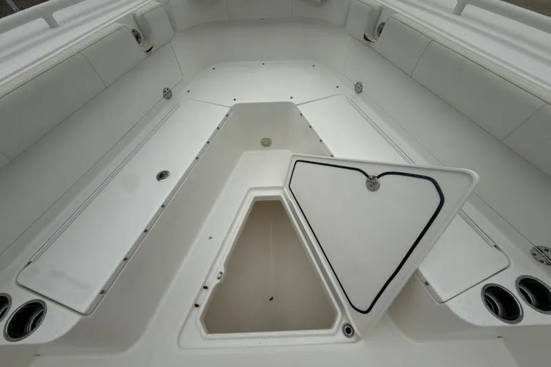Slide: The Image of 2016 Everglades 295 Center Console boat interior with open storage compartment. - 17