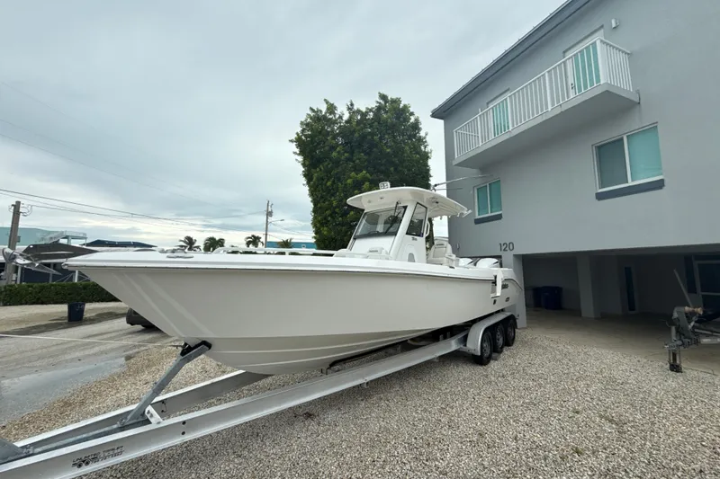 Slide: The Image of 2016 Everglades 295 Center Console boat on trailer near building. - 2