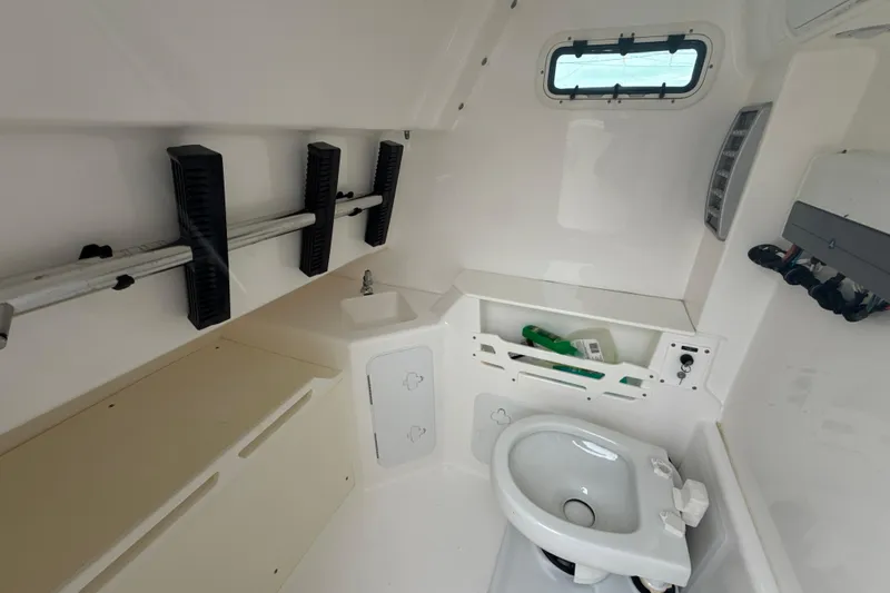 Slide: The Image of Interior of 2016 Everglades 295 Center Console boat with sink and toilet. - 22