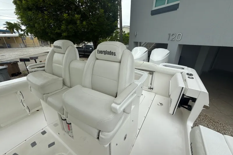 Slide: The Image of 2016 Everglades 295 Center Console boat with white seating and dual engines. - 25