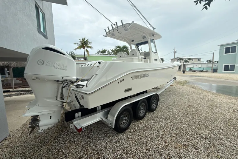 Slide: The Image of 2016 Everglades 295 Center Console boat on trailer with Yamaha engine, parked outdoors. - 6