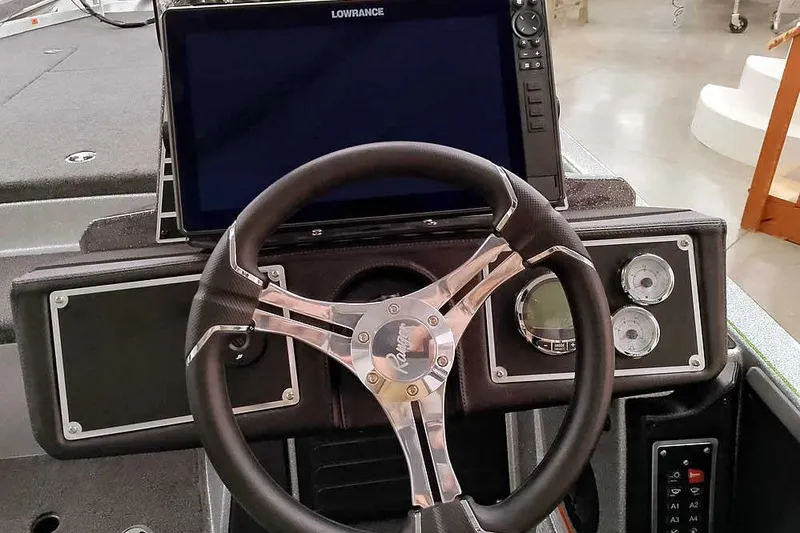 Slide: The Image of 2026 Ranger Z521 boat dashboard with steering wheel and Lowrance display. - 27