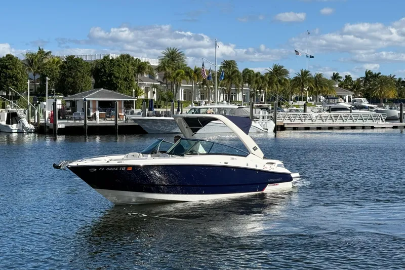 Slide: The Image of 2017 Monterey 298SS Super Sport boat docked in a marina under a clear blue sky. - 13