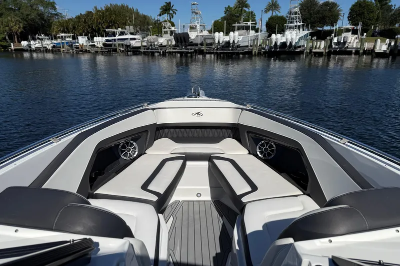 Slide: The Image of 2017 Monterey 298SS Super Sport boat interior with seating, docked by a marina. - 19