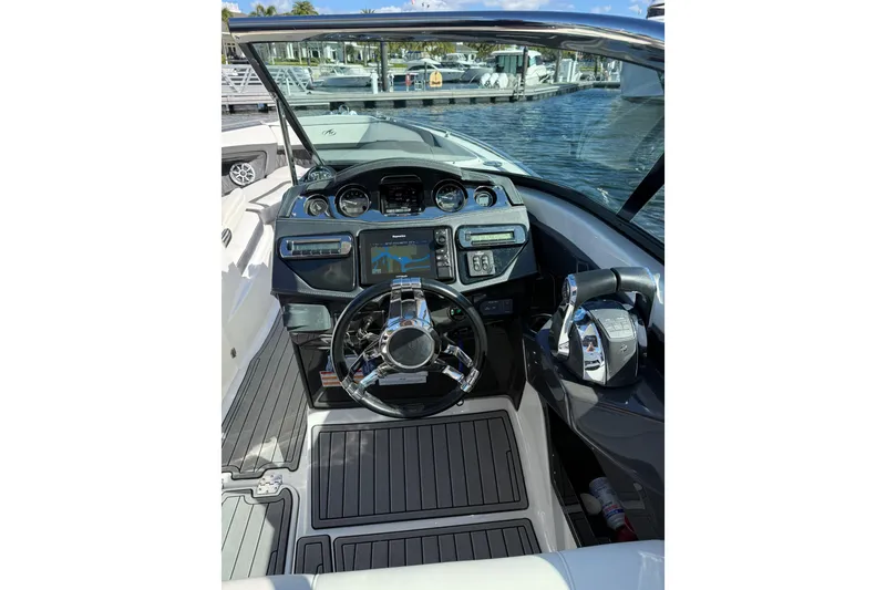 Slide: The Image of Cockpit of 2017 Monterey 298SS Super Sport boat with modern controls and steering wheel. - 28