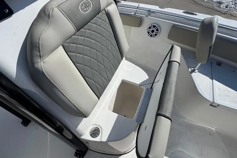 Slide: The Image of 2026 Key West 219 FS boat seat with storage compartment, featuring gray and white upholstery. - 11