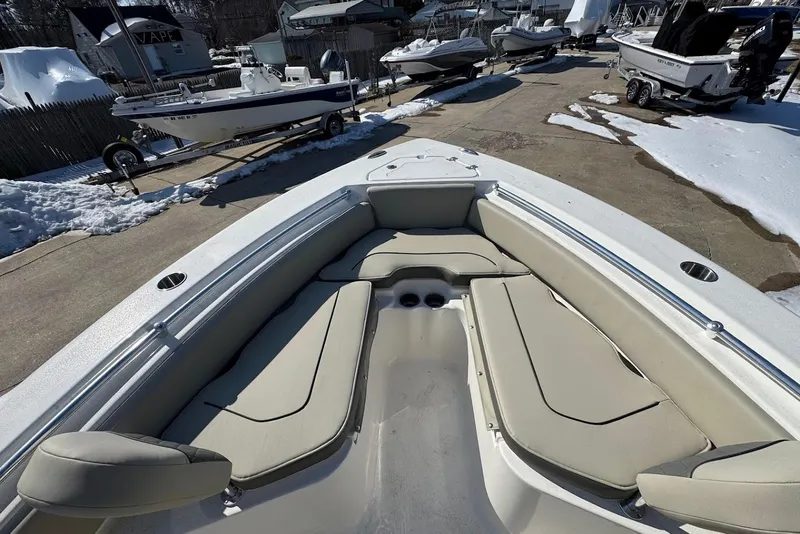 Slide: The Image of 2026 Key West 219 FS boat with beige seating, parked on snowy pavement. - 14