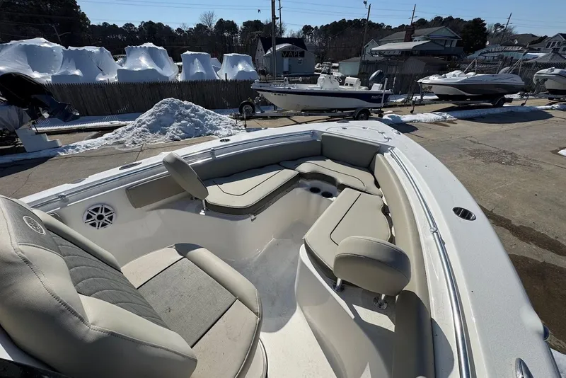 Slide: The Image of 2026 Key West 219 FS boat interior with seating, parked outdoors in a snowy setting. - 15