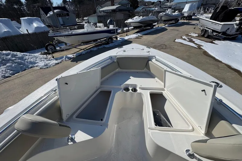 Slide: The Image of 2026 Key West 219 FS boat with open storage compartments, parked in snowy marina. - 9
