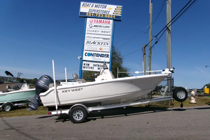 The Image of 2021 Key West 189 FS boat on trailer at dealership, clear sky background. - 0