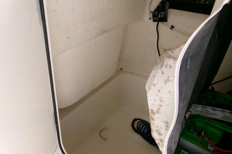 Slide: The Image of Interior storage compartment of 2021 Key West 189 FS boat with visible battery. - 11