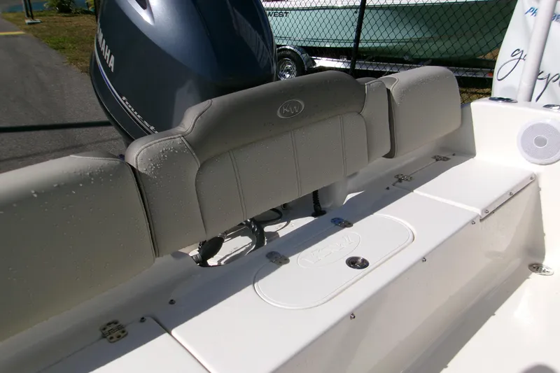 Slide: The Image of 2021 Key West 189 FS boat interior with Yamaha engine, featuring cushioned seating and storage. - 8