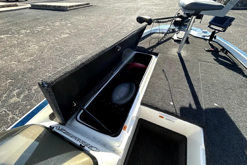 Slide: The Image of 2003 Champion 187 CX boat with open storage compartment and fishing seat. - 11