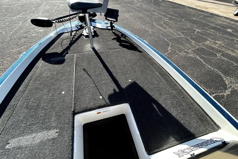 Slide: The Image of 2003 Champion 187 CX boat deck with trolling motor and carpeted surface. - 14