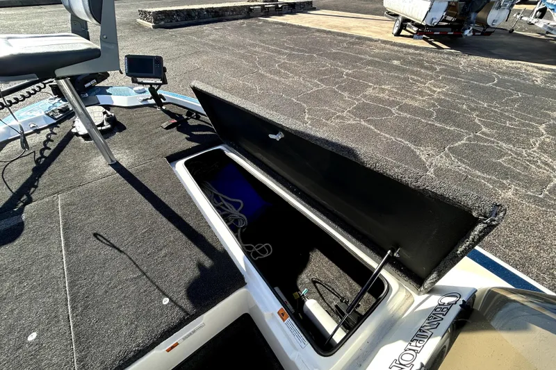 Slide: The Image of 2003 Champion 187 CX boat deck with open storage compartment and fishing seat. - 15