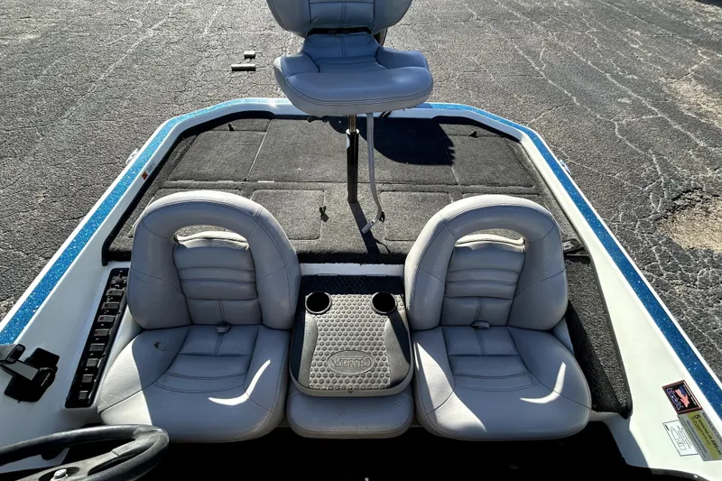 Slide: The Image of 2003 Champion 187 CX boat interior with three gray seats and cup holders. - 16