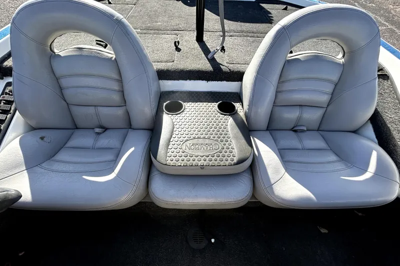 Slide: The Image of 2003 Champion 187 CX boat interior with dual gray seats and center console. - 18