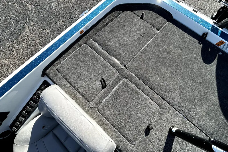 Slide: The Image of 2003 Champion 187 CX boat interior with gray carpet and seating. - 19