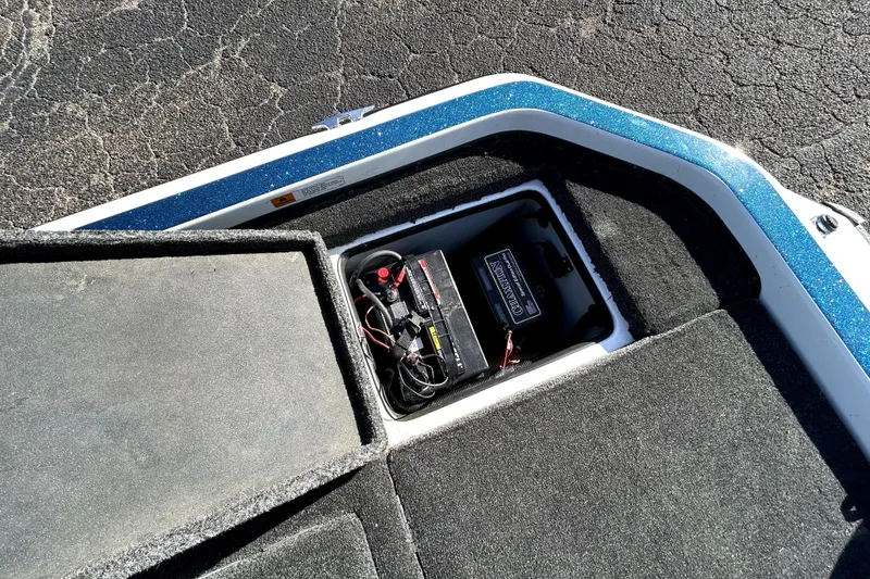 Slide: The Image of Open battery compartment in 2003 Champion 187 CX boat, showing wiring and battery. - 22