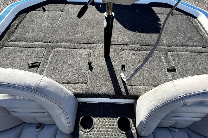 Slide: The Image of 2003 Champion 187 CX boat interior with carpeted deck and seating. - 23