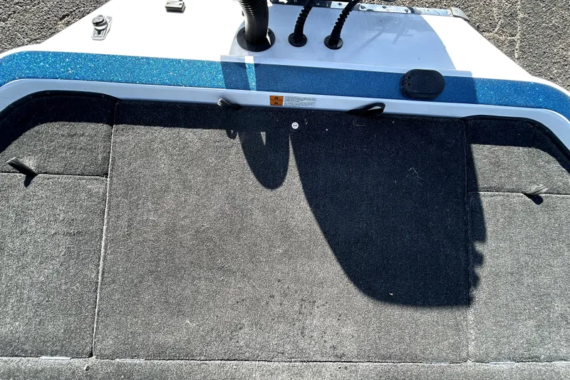 Slide: The Image of 2003 Champion 187 CX boat deck with blue trim and carpeted surface. - 29